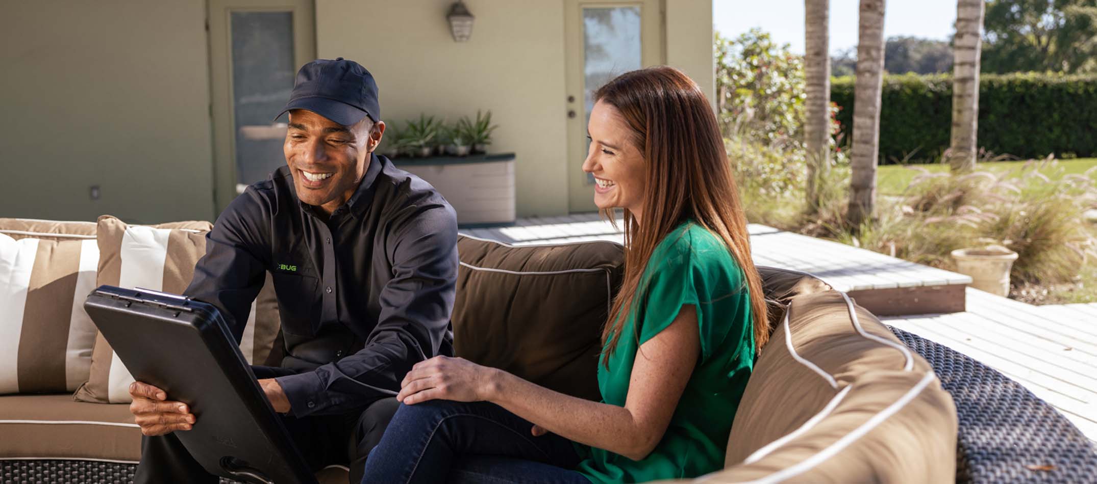 Bug Out pest control technician reviewing a pest control quote with a customer
