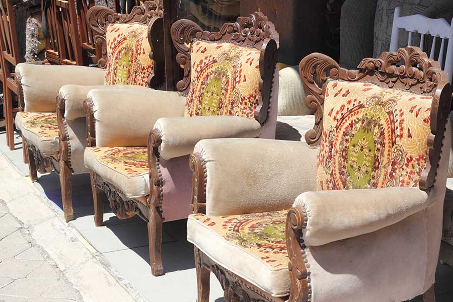 Line of used armchairs outside