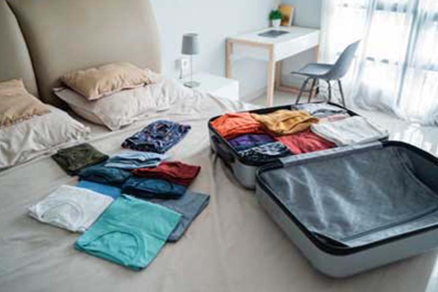Unpacked luggage on bed