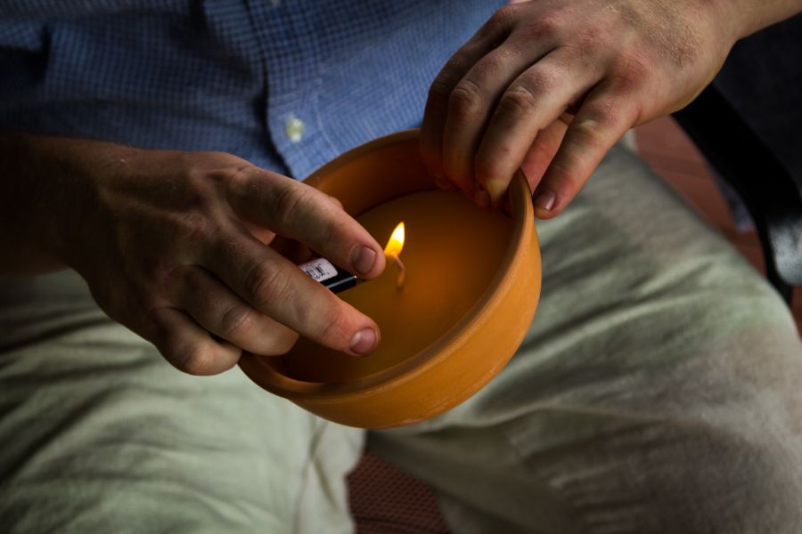 Person lighting citronella candle